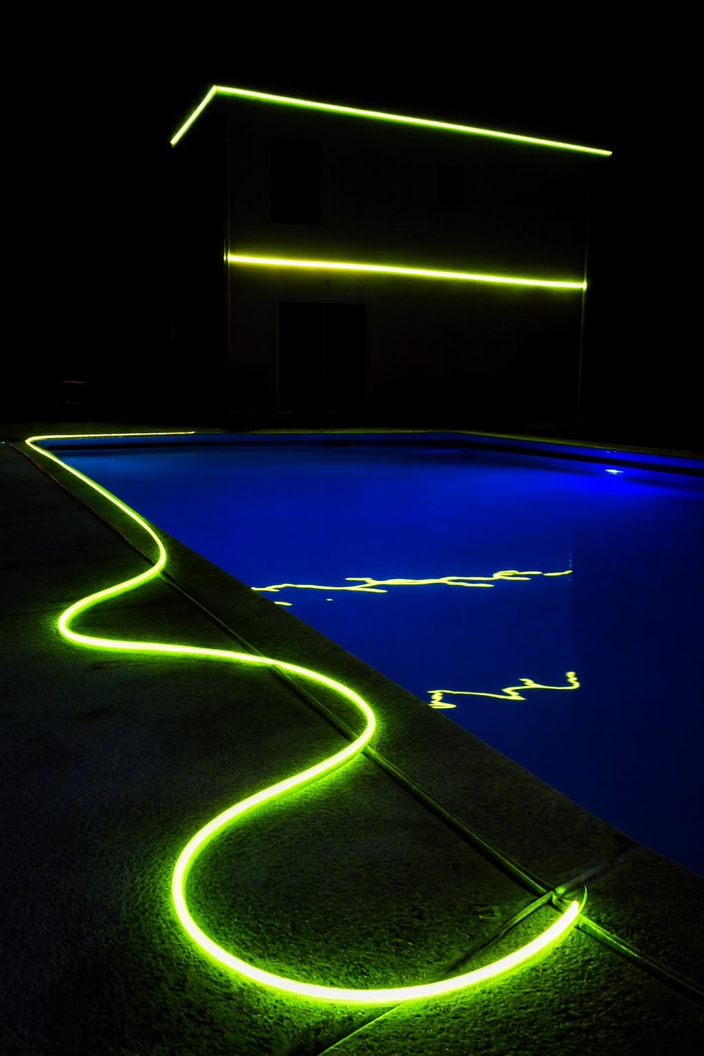 Different LED pool lighting effects in a modern backyard pool